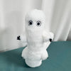 A white plush toy resembling a ghost with large black eyes and small black hands.