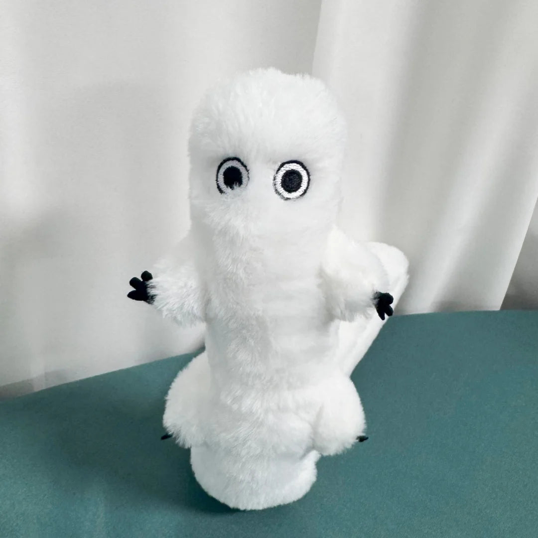 A white plush toy resembling a ghost with large black eyes and small black hands.