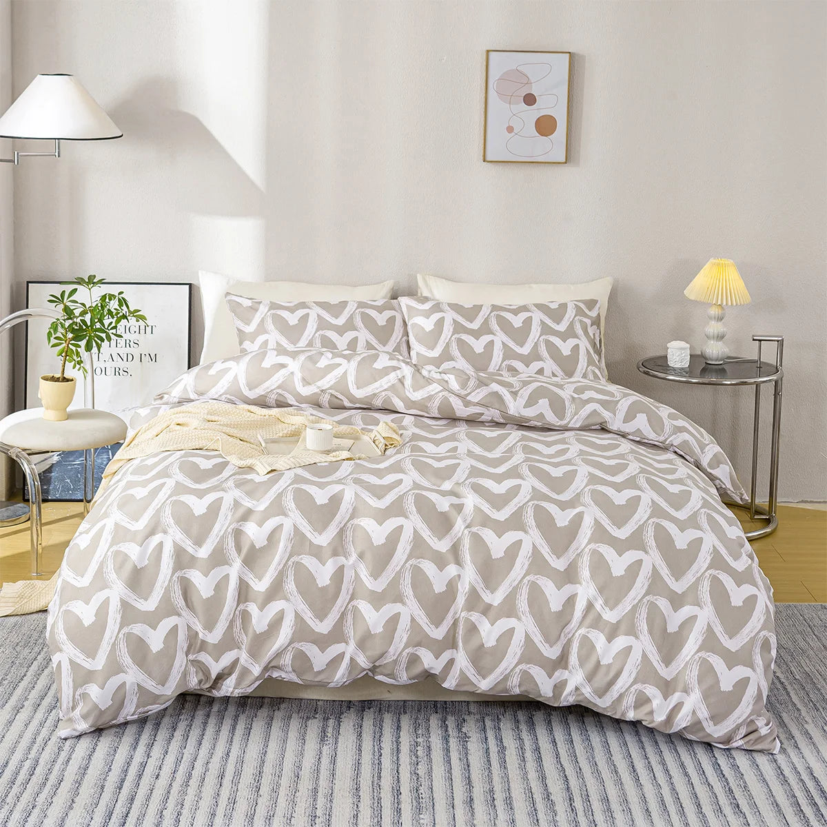 A bed with a heart print duvet cover set in soft blue and gray tones, featuring pillows and bedside lamps.
