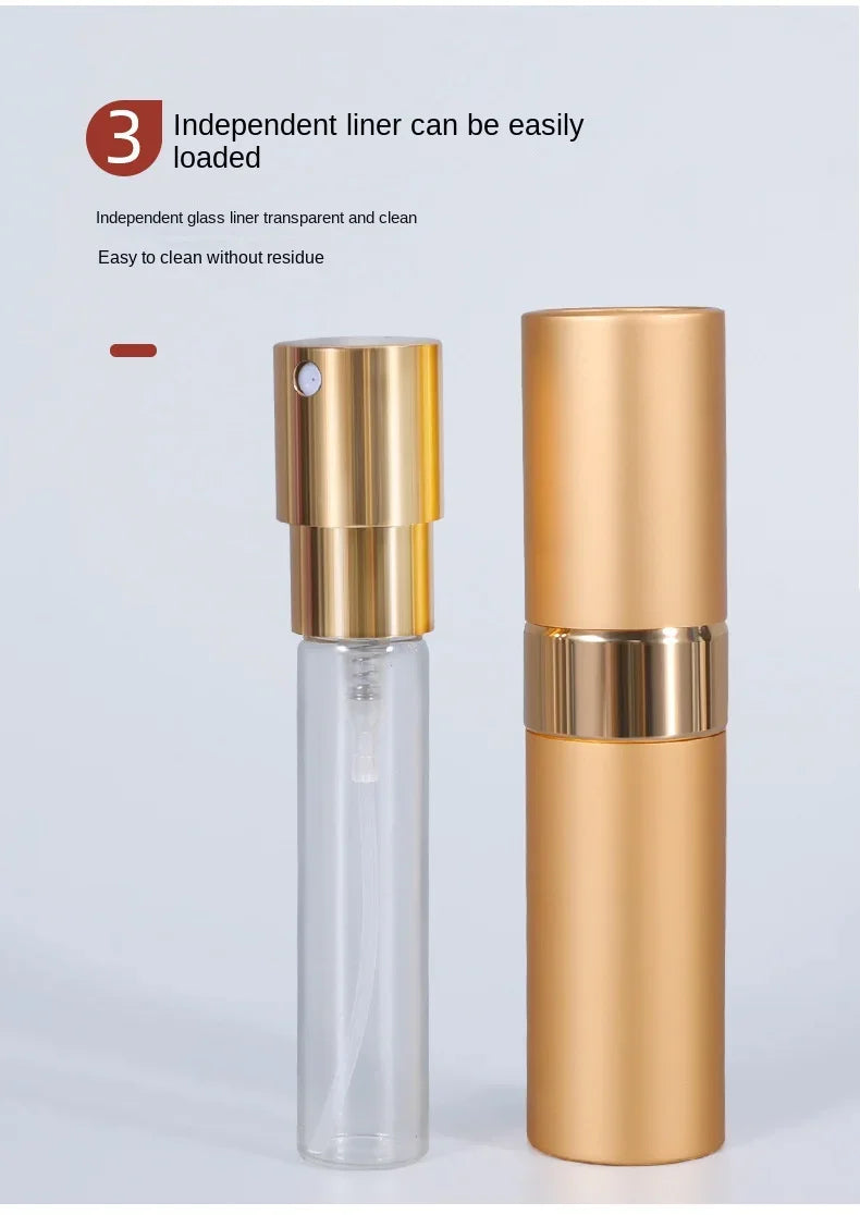 A clear glass atomizer bottle with a gold-colored cap and a matching cylindrical aluminum body.