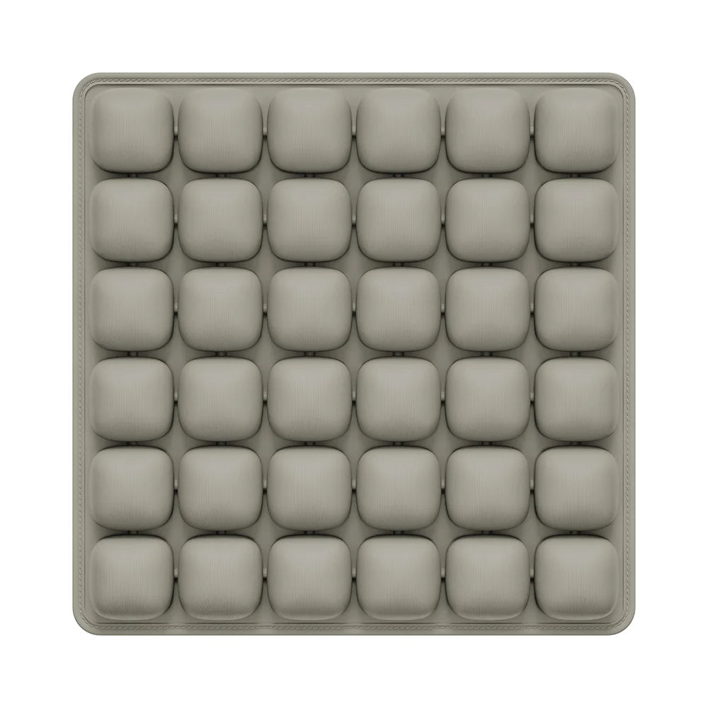A gray, square seat cushion with multiple individual pockets for an adjustable press-to-inflate design.