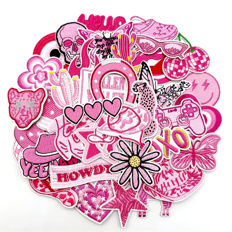 Assorted pink embroidered iron-on patches for DIY clothing and accessories featuring various shapes and designs
