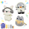 A crochet kit featuring three stuffed animal figures: a white cat, a gray owl, and a gray cat, along with yarn and needles.