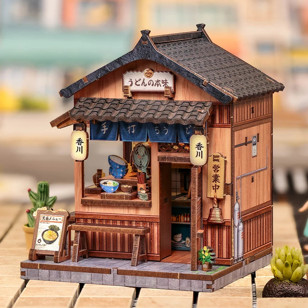 A detailed miniature Japanese book nook kit featuring a traditional wooden shop facade with lighting elements.