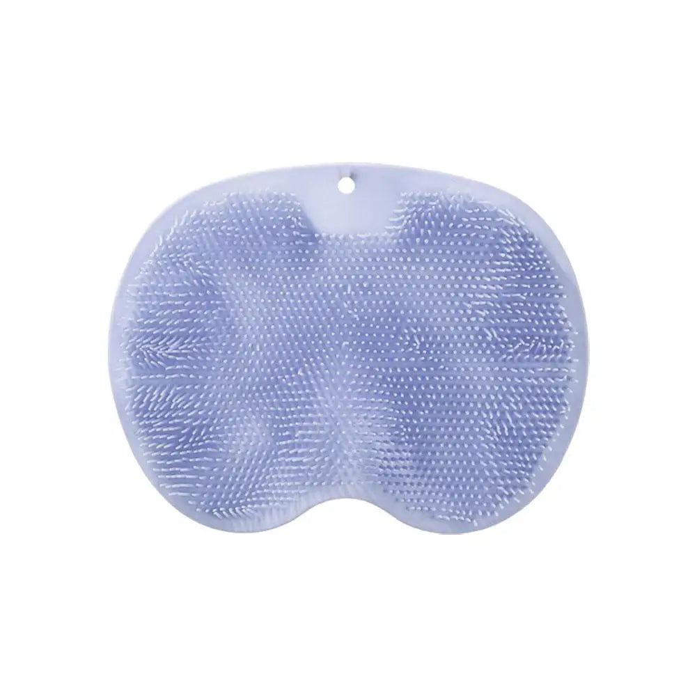 A light blue ergonomic silicone foot scrubber with a suction base.