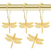 A set of twelve gold-colored dragonfly shower curtain hooks hanging from a brass rod.