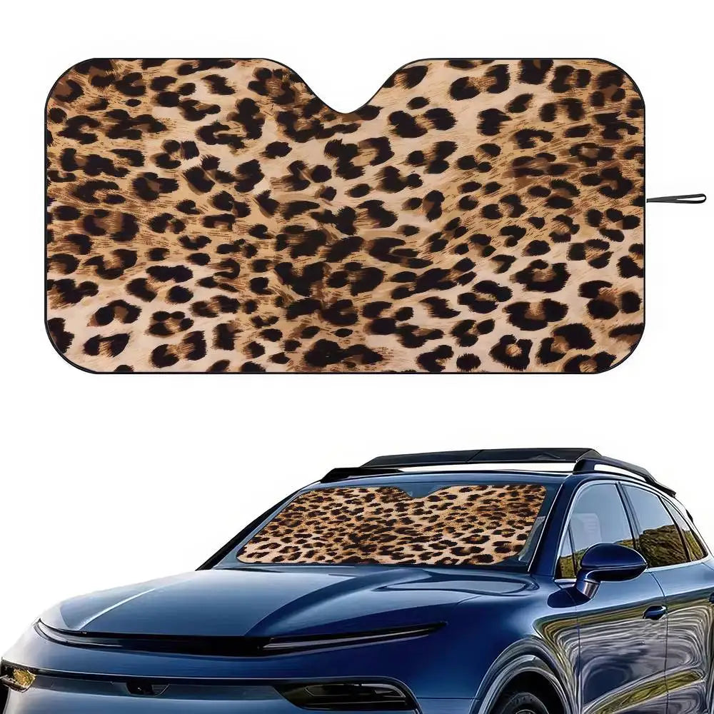 Leopard print car windshield sunshade placed on a blue car windshield.