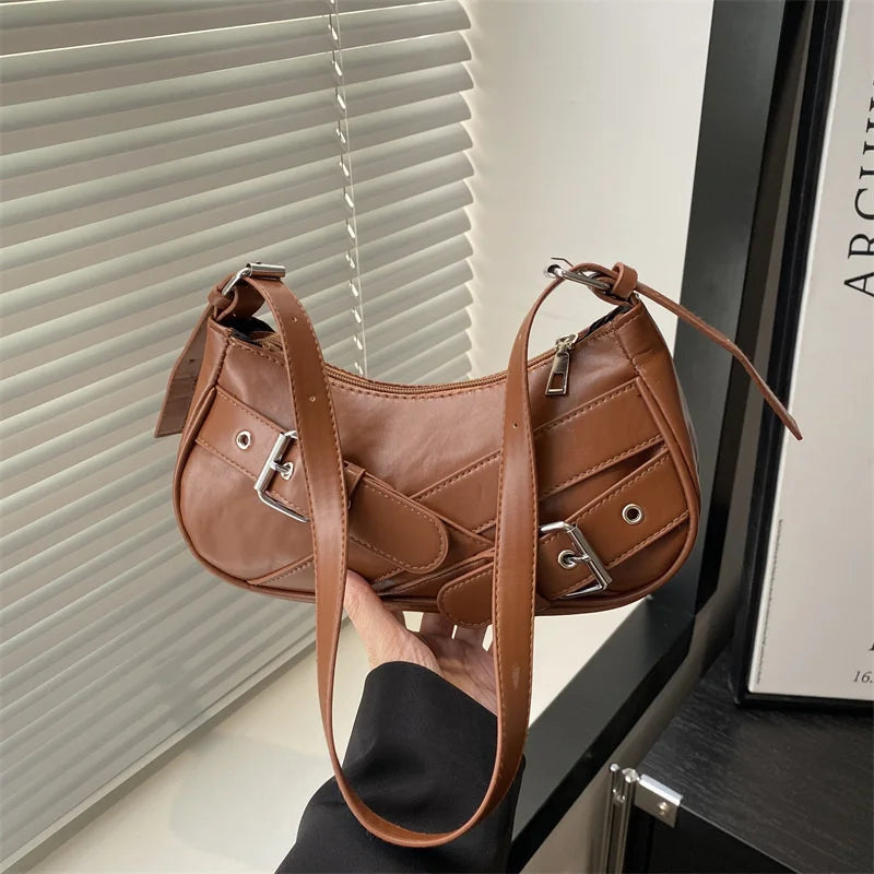 A brown PU leather crossbody bag with a flap and strap is displayed against a light background.