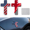 A silver and red 3D USA flag cross emblem for a car, alongside a red and silver emblem and a blank metal plate.