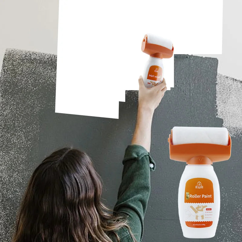 A person is using an orange and white roller paint tool to apply paint on a gray wall.