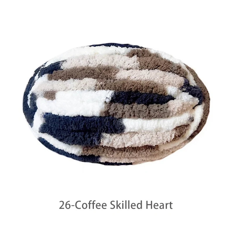 A round, textured chenille yarn in a black and beige striped pattern.