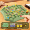 A green plastic tray holds various animal stickers and yellow chess pieces for an interactive memory game.