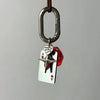 Silver keychain charm featuring a red dice heart design with a D-shaped buckle.
