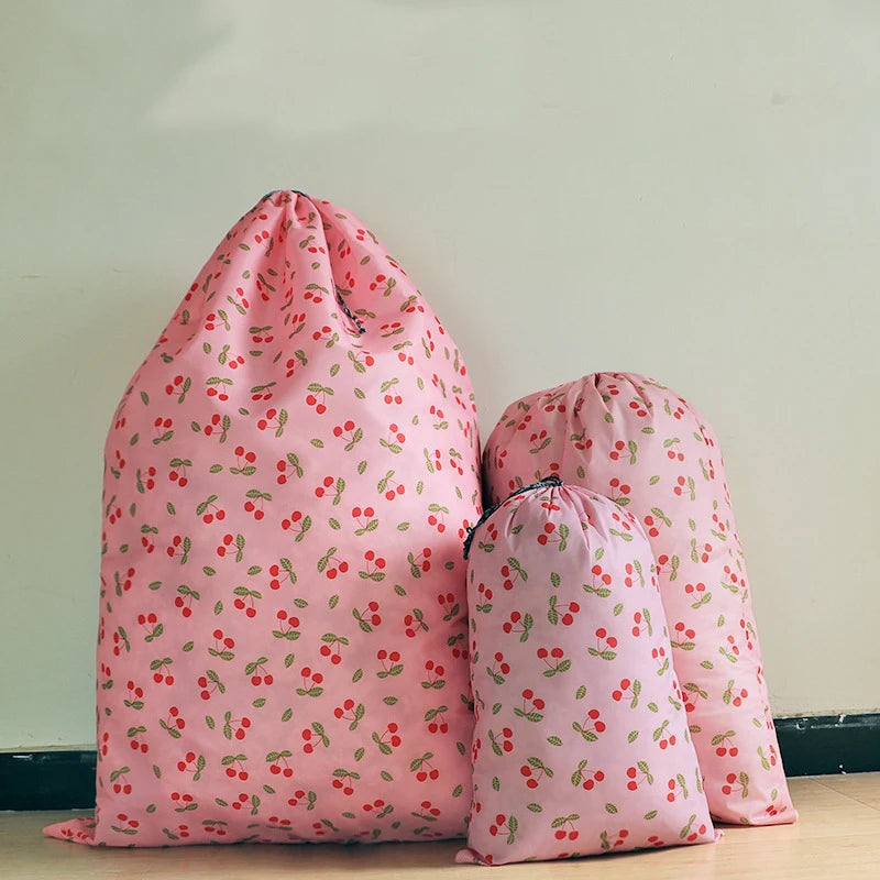 Pink drawstring laundry bag with a floral pattern shown in a vertical arrangement.