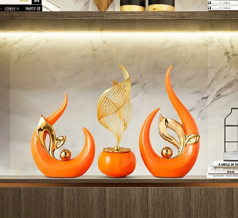 An orange ceramic sculpture shaped like a stylized leaf or flame, displayed in a modern shelf setting.
