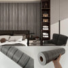 Close-up view of self-adhesive wood grain wall panels installed on a dark gray interior wall.