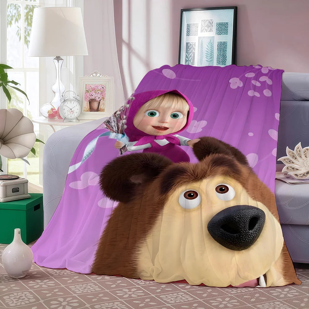 A cartoon fleece throw blanket featuring Masha and the Bear characters in purple and brown tones.