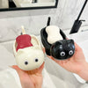 A hand holds a black and white cat-shaped soap box with a drainage tray.