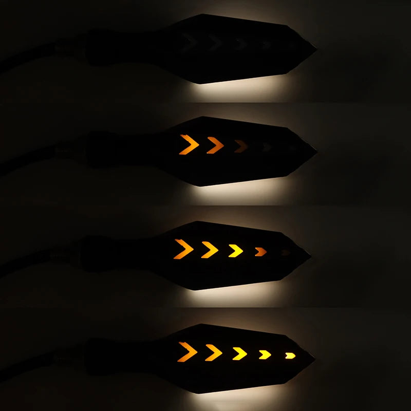 Three illuminated motorcycle turn signal indicators showing yellow and orange flashing patterns.