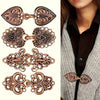 A set of vintage rose gold rotating sweater clips for cardigans and shawls shown against a gray knitted garment.