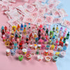 A collection of miniature resin food and drink figurines in various colors and shapes for DIY decor.