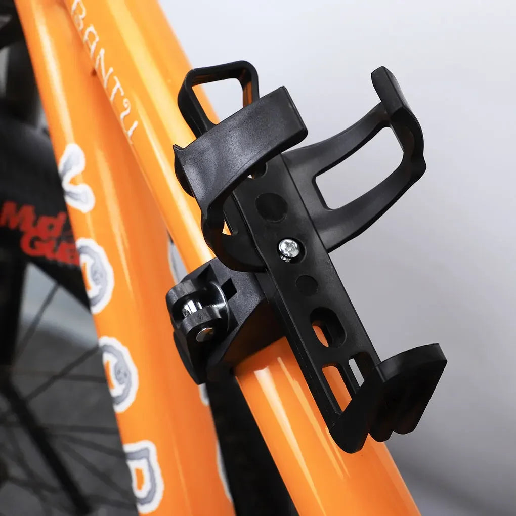 A black rotatable bicycle water bottle cage mounted on an orange bicycle frame.