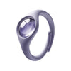 A close-up of a light purple wristband with a clear lens, designed as a natural mosquito repellent.