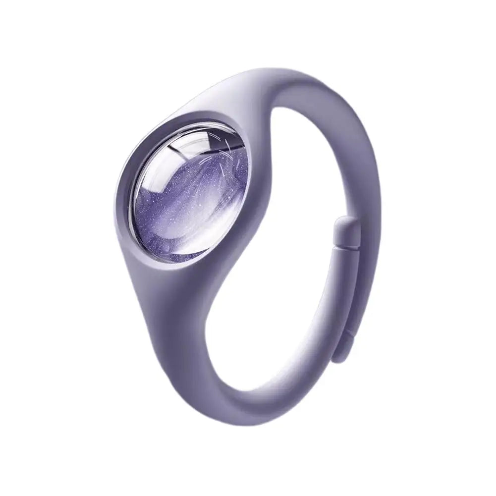 A close-up of a light purple wristband with a clear lens, designed as a natural mosquito repellent.