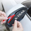 A hand is inserting a red strip into the X-TRAIL rain guard for car side mirrors.