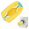 Yellow mesh shoe wash bag with a soft protective lining placed next to a washing machine.