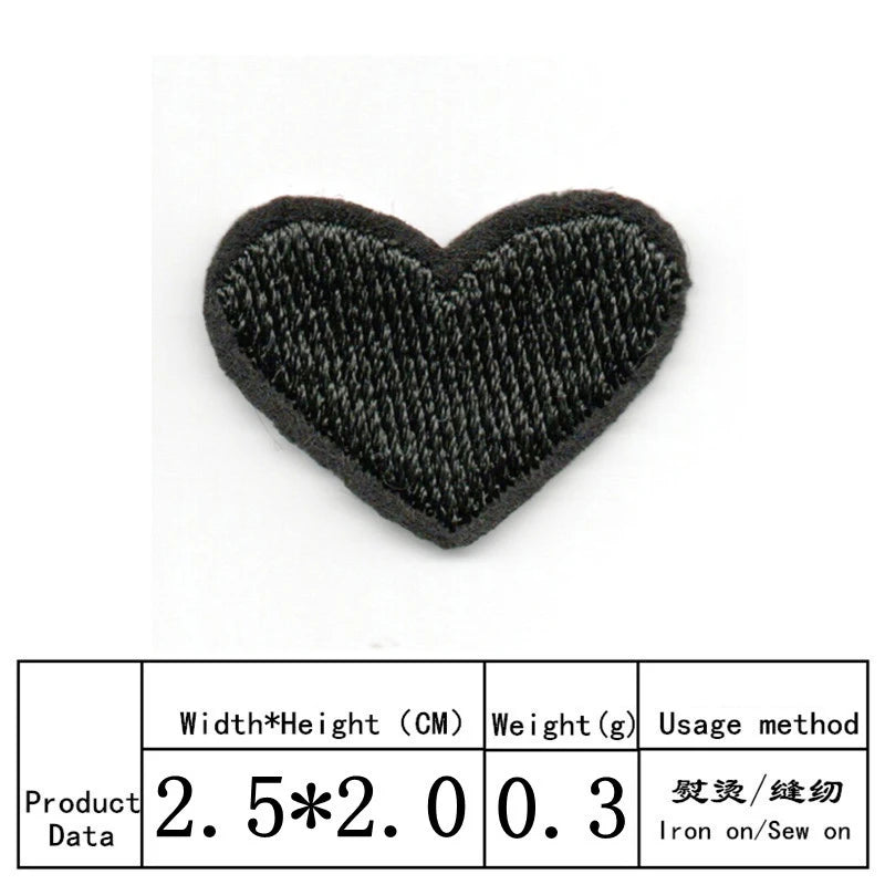 A black heart shaped iron-on patch with embroidered texture.