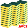 A stack of three green and yellow dual-sided scrub sponges for kitchen cleaning.