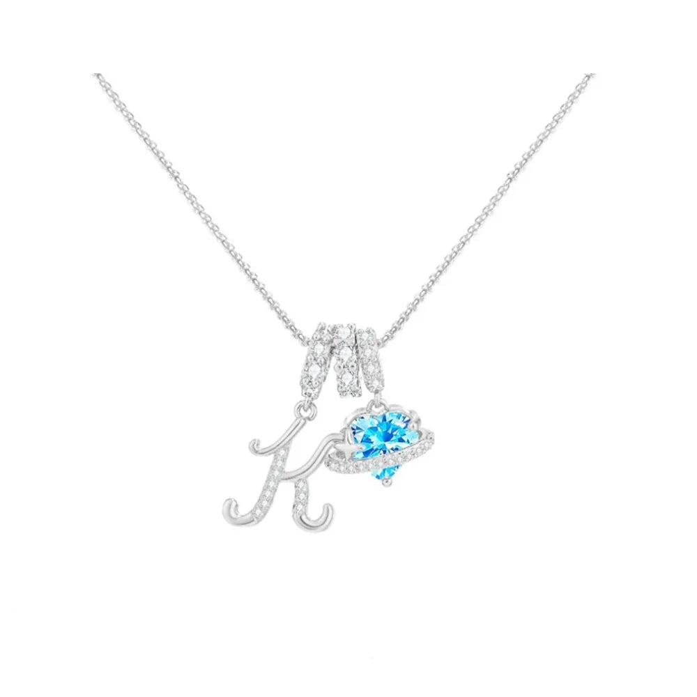 A diamond heart-shaped initial pendant necklace featuring a sparkling letter K.