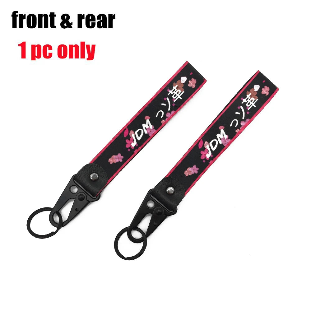 A black strap with pink floral embroidery and a silver clasp, sold as a front & rear set of 1 piece only.