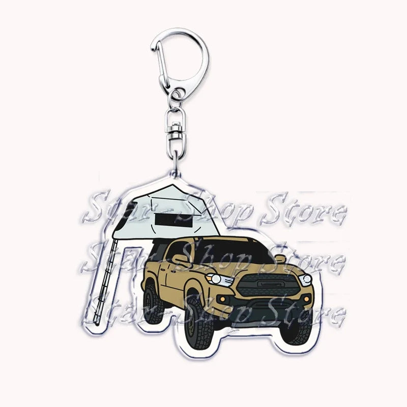 A silver metal key ring attached to a keychain featuring a detailed model of a yellow off-road truck.