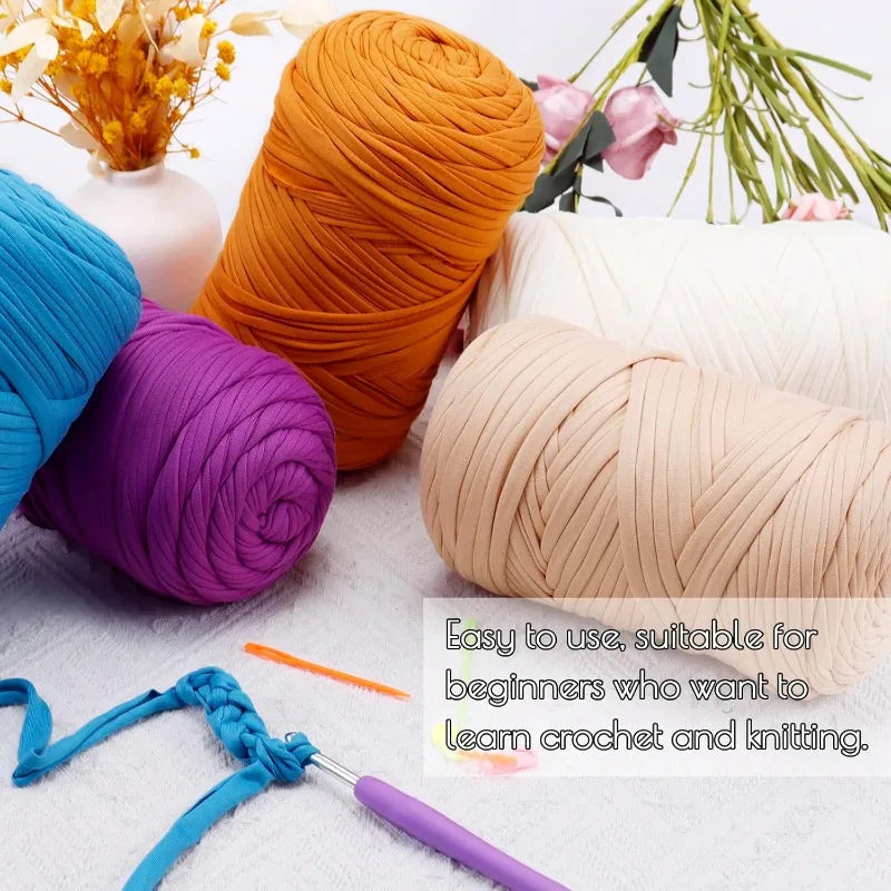 A collection of thick orange, purple, and beige yarn skeins with crochet hooks and needles for beginners.