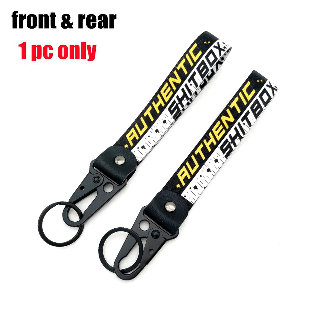 Front and rear authentic Shitbox JDM-style eagle beak clasp keychains sold as a single piece.