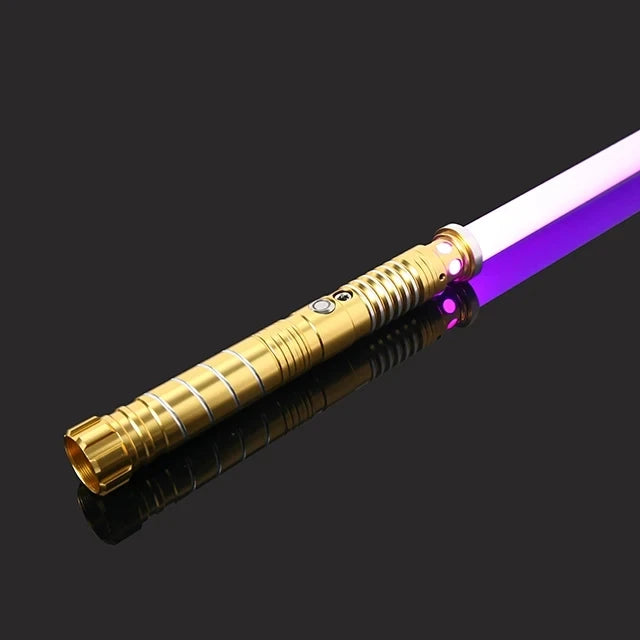A close-up view of an RGB metal lightsaber with a gold hilt and a purple blade against a dark background.