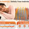 A woman is using an adjustable electric heating pad on her back for pain relief and warmth.