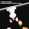 A white rabbit patch is shown hanging from a clear surface, demonstrating strong stickiness and standing upright.