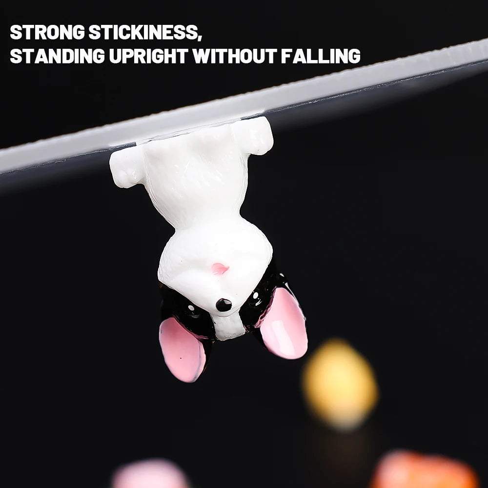 A white rabbit patch is shown hanging from a clear surface, demonstrating strong stickiness and standing upright.