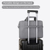 A gray portable laptop bag with a handle is shown attached to a black suitcase.