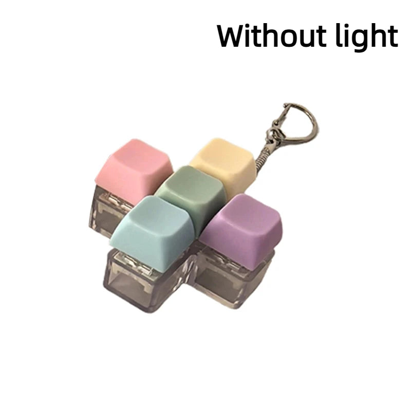 A set of five pastel colored LED mechanical keychain fidget toys with custom keycaps displayed against a white background.