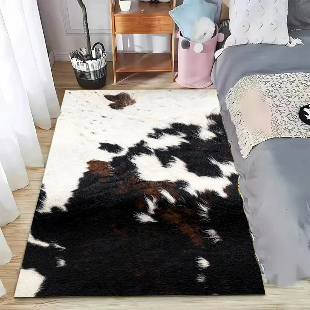 A black and white faux cowhide pattern area rug placed on a wooden floor next to a bed.