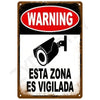 A vintage metal tin sign with a red warning oval and black text indicating a monitored zone.