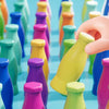 Colorful rainbow bottle bodies arranged in a row, showing various shades of green, yellow, purple, and blue.