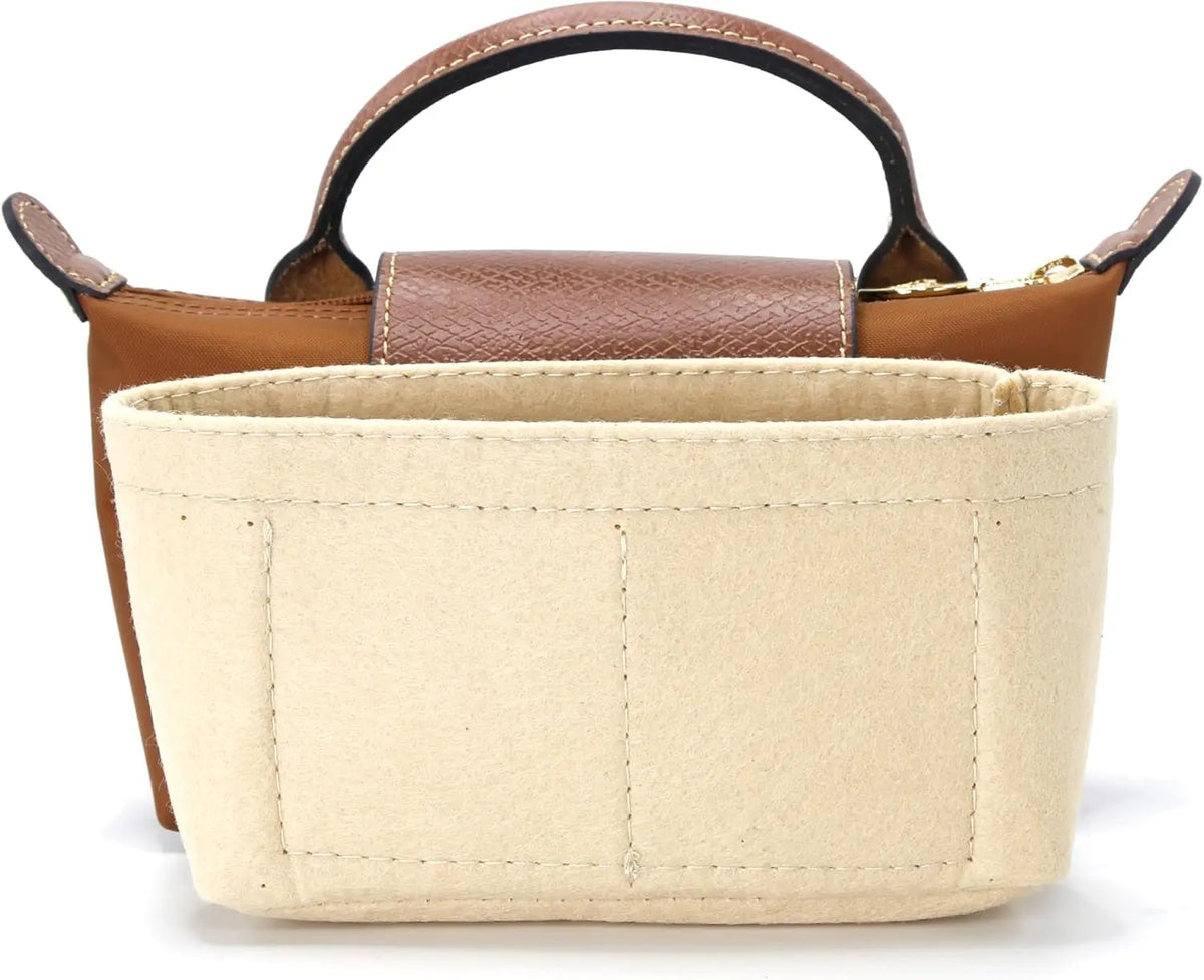 A light beige leather mini bag with a brown strap and wooden accents.