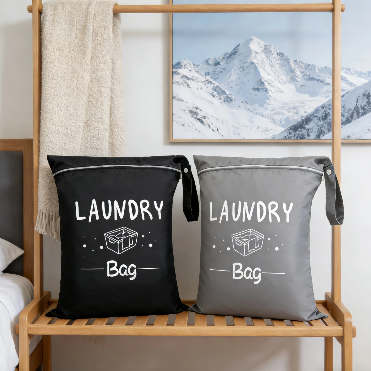 Two gray and black fabric laundry bags are displayed on a wooden rack against a white wall.