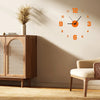 A modern wall clock with orange numerals and hands is displayed on a beige wall next to wooden furniture.