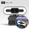 A black 4K Full HD webcam with a built-in fill light and auto-focus feature.
